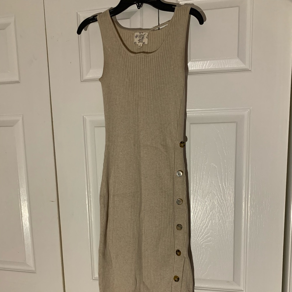 Knee length form fitting creme colored dress.